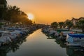 Kusadasi, Aydin, Turkey - August 22, 2021: Many boats parked on a pier in Sevgi Beach at sunset