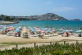 KUSADASI, TURKEY - AUGUST 20, 2017: Beautiful sand beach of Kusadasi with colorful straw umbrellas and lounge chairs, Aegean Sea Royalty Free Stock Photo