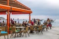 Kusadasi, Turkey, 05/19/2019: People relax in a cafe on the sea coast. They walk, eat, chat, laugh