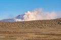 Kusasenri prairie in January, fuming Mt. Naka in the background Royalty Free Stock Photo