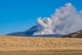 Kusasenri prairie in January, fuming Mt. Naka in the background Royalty Free Stock Photo