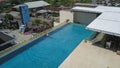 Kuta, Bali, Indonesia, March 13, 2021. Aerial footage of a man in the pool on the roof of luxury hotel Atanaya. A drone