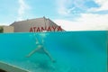 Kuta, Bali, Indonesia, March 14, 2021. Underwater photo of caucasian man diving in the swimming pool with transparent