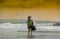 Tourist girl waiting ocean , Kuta Beach, Bali