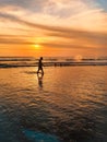 Kuta beach,Bali-11/13/2019:Man walkinng at the Kuta beach, Bali in the evening