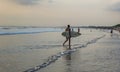 A surfer is completed activities at Kuta Beach, Bali-Indonesia Royalty Free Stock Photo