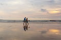 Kuta, Indonesia - March 26, 2019 : Loving couple walks along the beach at sunset