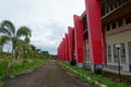 Kutai Barat Indonesia - January 10 2021: This large red sports arena was built environmentally friendly with beautiful nature