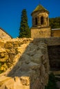 KUTAISI, GEORGIA: View of the old stone Bell Tower in the Orthodox monastery of Gelati on a sunny summer day. UNESCO. Royalty Free Stock Photo