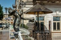 Kutaisi, Georgia - June 8, 2019. Bronze Statue of Boy with hats in his hands on White Bridge,Tetrikhidi, across river Rioni.