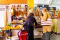 Market stall with local sweets and vegetables, lady selling products to customer in Kutaisi Central Market.