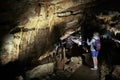 Kutaisi, Georgia - October 24, 2019: Tourists in beautiful colorful and illuminated cave with stalactites and stalagmites