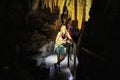 Kutaisi, Georgia - October 24, 2019: Tourists in beautiful colorful and illuminated cave with stalactites and stalagmites