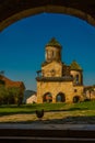 KUTAISI, GEORGIA: View of the old stone Bell Tower in the Orthodox monastery of Gelati on a sunny summer day. UNESCO. Royalty Free Stock Photo