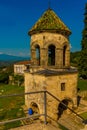 KUTAISI, GEORGIA: View of the old stone Bell Tower in the Orthodox monastery of Gelati on a sunny summer day. UNESCO. Royalty Free Stock Photo