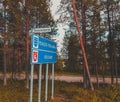 KuusamoNorthern Finland, road sign telling of entering Pohjois-Pohjanmaa and Kuusamo Royalty Free Stock Photo