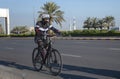 One Cyclist riding bicycle on empty street wearing face mask