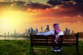 Kuwaiti man looking at kuwait city during sunset