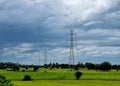 The 230kV transmission line towers on a rice field in the countryside Royalty Free Stock Photo