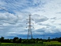 The 230kV transmission line towers on a rice field in the countryside Royalty Free Stock Photo