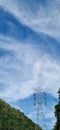 150 kV transmition line of electricity in the middle of mountain with blue sky and a beautiful clouds Royalty Free Stock Photo