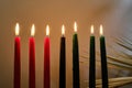 Kwanzaa Candles. Lit Kwanzaa candles in red, black, and green symbolize unity and celebration. Royalty Free Stock Photo