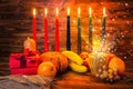 Kwanzaa holiday concept with traditional lit candles, gift box,