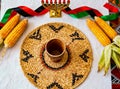 Kwanzaa table setting with kinara, corn, and woven mat for cultural celebration Royalty Free Stock Photo