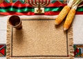 Kwanzaa table setting with kinara, corn, and woven mat for cultural celebration Royalty Free Stock Photo
