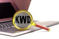 KWD word on magnifier on laptop , white background Royalty Free Stock Photo