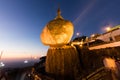 Kyaikhtiyo or Kyaiktiyo pagoda, Golden Rock, Myanmar with pilgrims during sunset