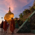 Kyaikhtiyo or Kyaiktiyo pagoda, Golden Rock, Myanmar with pilgrims during sunset