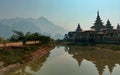 Kyaut Ka Lat Buddhist Temple reflecting in the water of the lake at sunset. Hpa-An, Myanmar. Royalty Free Stock Photo