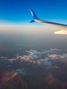 Kyiv - Dubai, November, 2018: View of the mountains from flydubai airplane window during flight at sunset