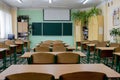 KYIV- Jan 10, 2019: selective soft and blur focus.old wooden row lecture chairs in classroom in poor school.study room without Royalty Free Stock Photo