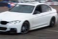 New BMW M3 F80 race car drifting on high speed with motion blur effect on race tracks on Drift And Cars Show Royalty Free Stock Photo