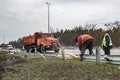 2022-04-09 Kyiv region, Ukraine. Road workers repair damaged highway E-40 after russian shelling