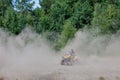 Kyiv- September 2019 Man riding a yellow quad ATV all terrain vehicle on a sandy forest. Extreme sport motion, adventure, tourist