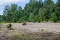 Kyiv- September 2019 Man riding a yellow quad ATV all terrain vehicle on a sandy forest. Extreme sport motion, adventure, tourist