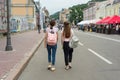 Kyiv UA, 19-07-2018. Young teenage girls students are walking through the streets of the city, the view from the back.