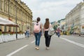 Kyiv UA, 19-07-2018. Young teenage girls students are walking through the streets of the city, the view from the back