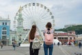 Kyiv UA, 19-07-2018. Young teenage girls are walking the streets of the city. Background Ferris wheel, square of the European city