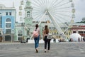 Kyiv UA, 19-07-2018. Young teenage girls are walking the streets of the city. Background Ferris wheel, square of the European city