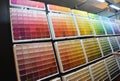 A customer is choosing the right interior paint color using the paint color palette in the store