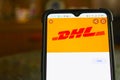 Kyiv, Ukraine - April 18, 2021: DHL tracking shipment app on s7, close to a parcel post.