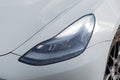 Kyiv, Ukraine. April 6, 2024. Headlight. LED headlamp of a modern gray electric car Tesla close-up