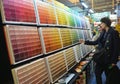 KYIV, UKRAINE - April 12, 2023: Interior color choice. Two women are choosing the right color in front of a large color palette in