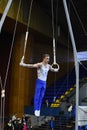 Male gymnast performing on stationary gymnastic rings Royalty Free Stock Photo