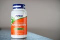 Kyiv, Ukraine - April 27, 2023: NOW Foods Ashwagandha root extract close-up on a blurred background. Plastic jar with testosterone