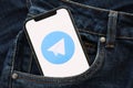 KYIV, UKRAINE - APRIL 1, 2024 Telegram messenger icon on smartphone display screen in jeans pocket Royalty Free Stock Photo